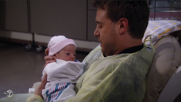 Jason holds his daughter.